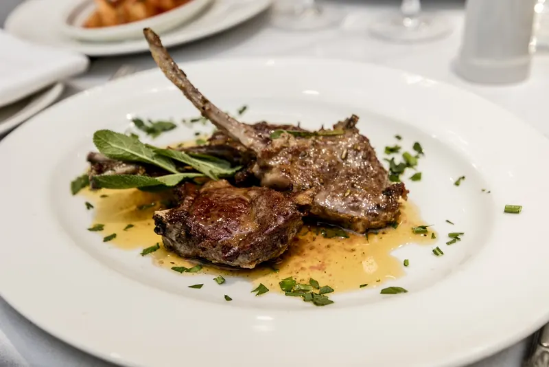 Grilled lamb cutlets with sage and a herb butter sauce