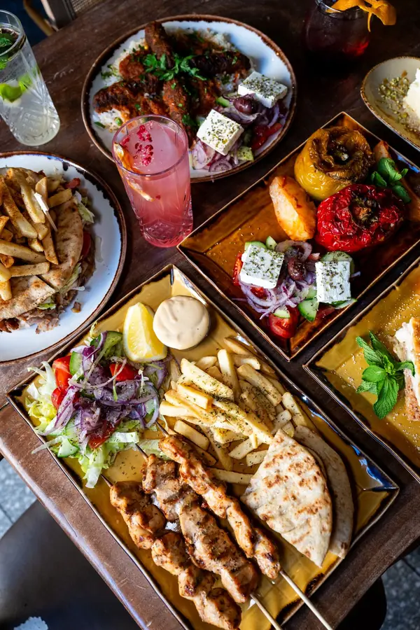 Overhead view of skewers, salads, dips and cocktails