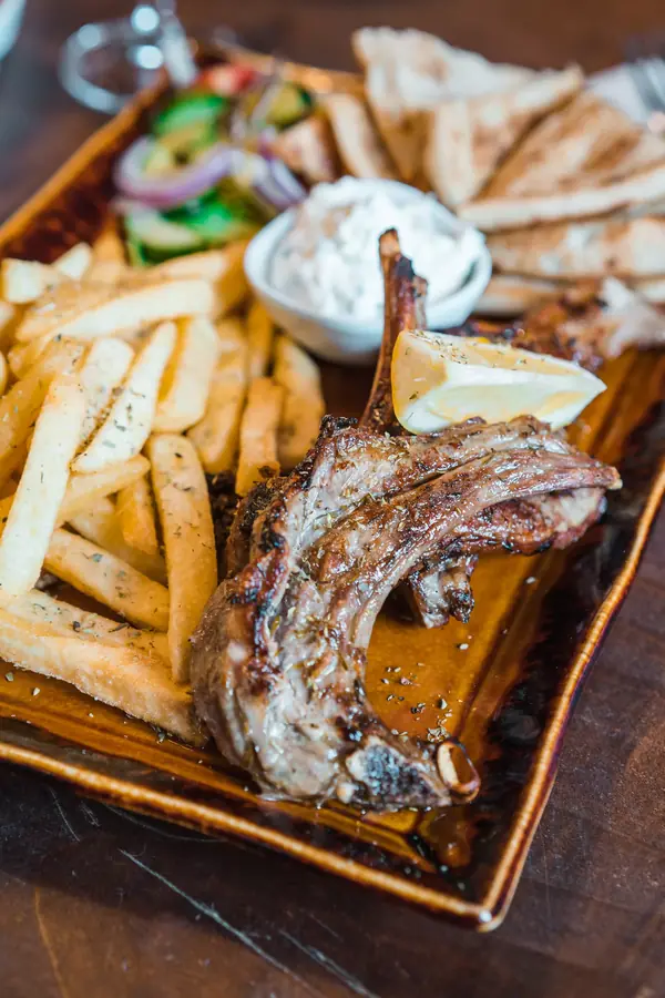 Grilled lamb chops with chips, salad and pitta