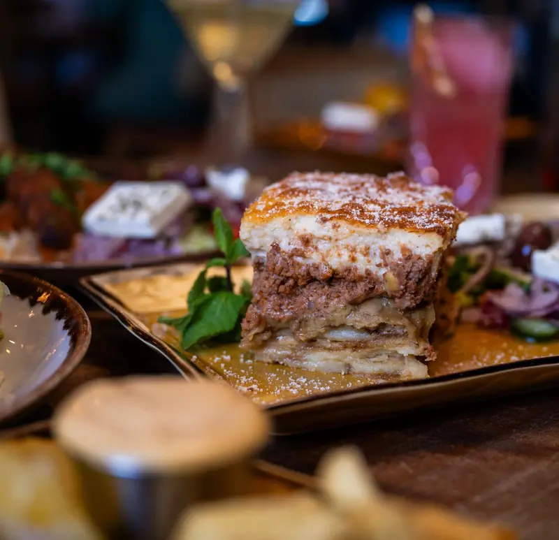 A slice of moussaka with Greek salad