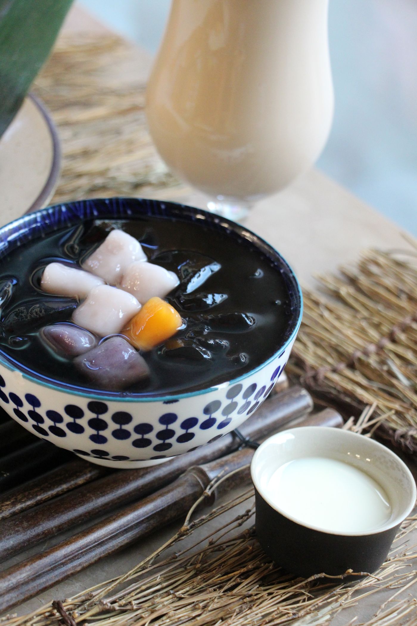 Taro balls on grass jelly with a glass of milk tea