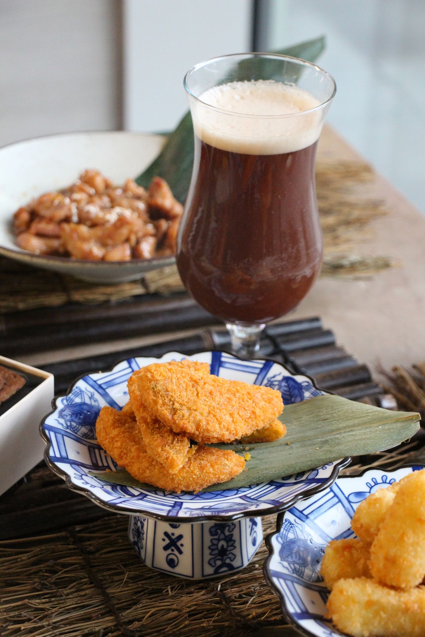 Tea being poured beside fried chicken and peanuts