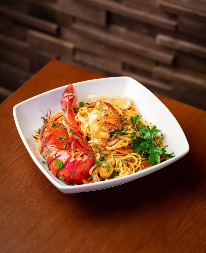 Lobster linguine in a white bowl